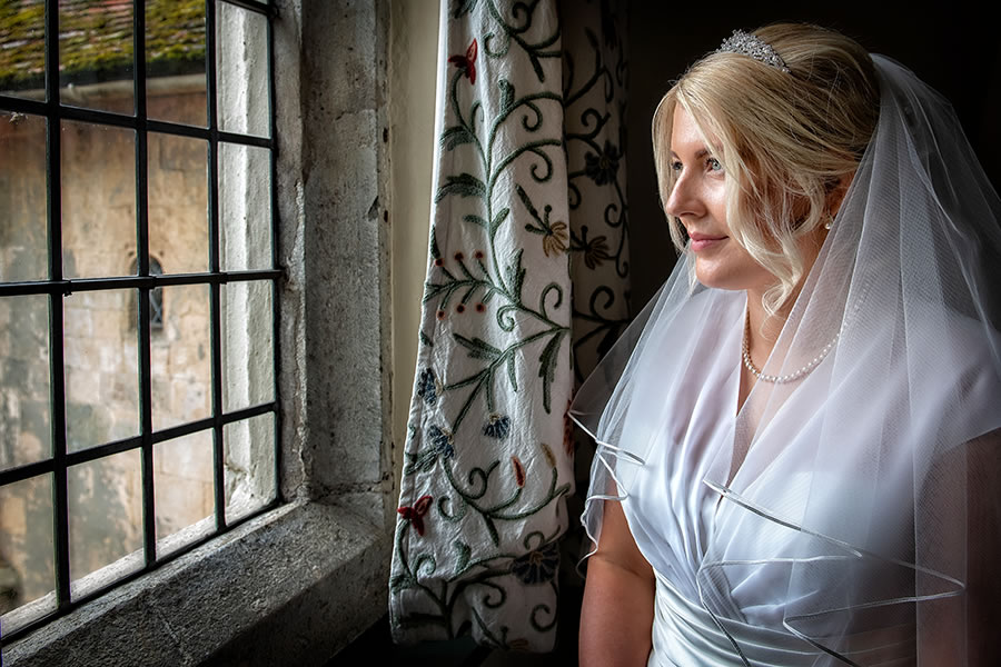 wedding photographer bride looking out of window wedding photographer - bride looking out of window